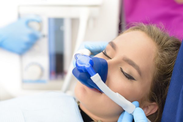 Young woman receiving nitrous oxide at our Novi dental office