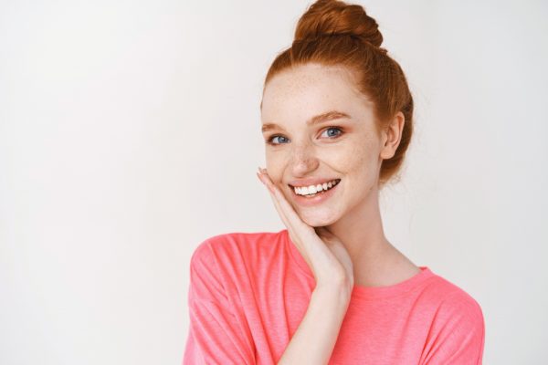 Young redheaded woman smiles